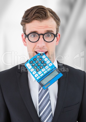 Man with calculator in mouth against blurry grey background