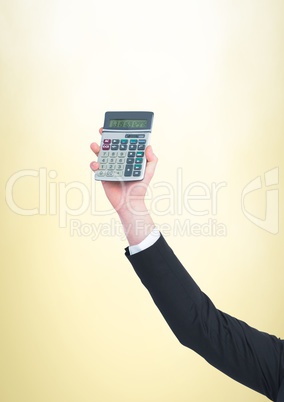 Hand with calculator against yellow background