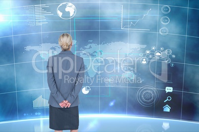 Businesswoman standing on from the back against graphics background