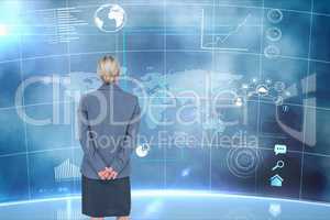 Businesswoman standing on from the back against graphics background