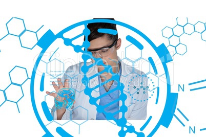 Scientist wearing safety glasses and a lab coat is working on a desk against DNA background