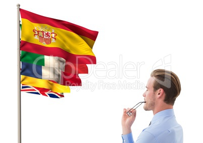 main language flags near young businessman thinking and looking to the flags