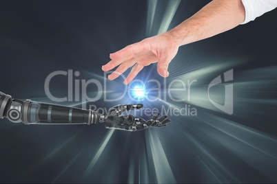 Connection between human and robot hand against silver background