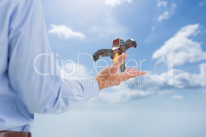 Part of businessman holding a rocket in his hand back to the photo