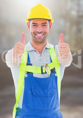 Construction Worker giving thumbs up in front of construction site