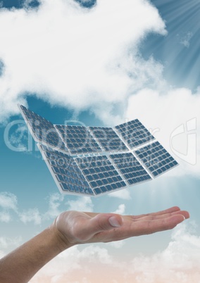 Digital composite image of solar panel on hand against sky