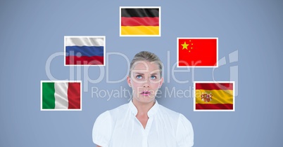 Businesswoman standing by various flags against blue background