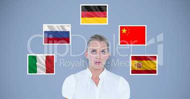 Businesswoman standing by various flags against blue background