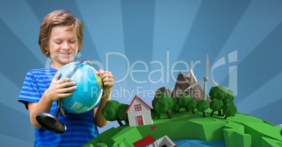 Smiling boy holding globe while standing against 3d image of planet earth against blue backeground