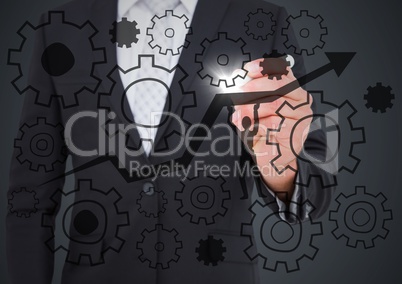 Business man mid section drawing cogs and arrow doodle with flare against grey background