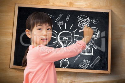 Young student against writing graphs on blackboard