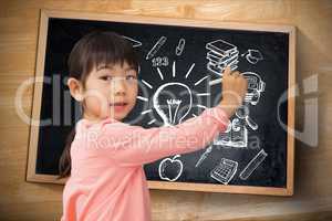 Young student against writing graphs on blackboard