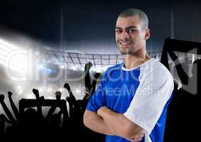 happy soccer player with blue t-shirt, in front of the fans and the field