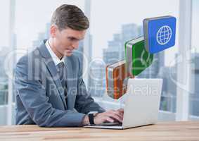 Businessman on laptop with apps icons against windows with city