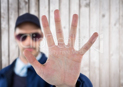 security guard whit his hand up saying stop. white wood