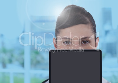 Businesswoman holding tablet in bright blue office