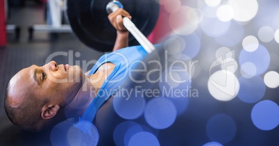 Man on ground weightlifting and blue bokeh transition