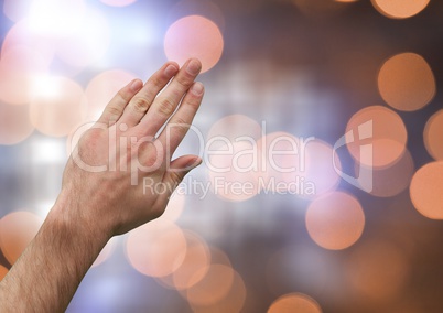 Hand touching brightness with sparkling light bokeh background