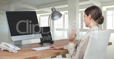 Businesswoman on computer at desk in office