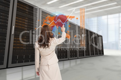 Businesswoman showing the graphics from the back against data center background