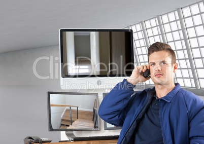 security guard phoning in front of the screens