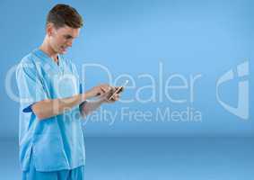 Doctor with a mobile phone against blue background