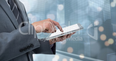 Businessman touching tablet by window