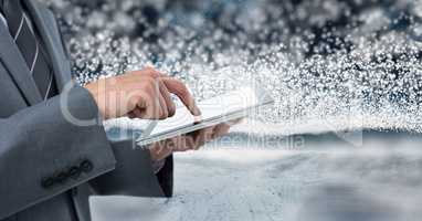 Businessman holding tablet with snow backgorund
