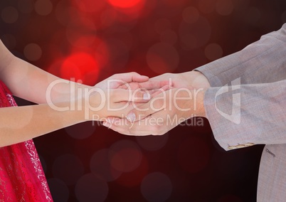 Hands holding together with sparkling light bokeh background