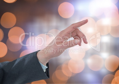 Hand pointing with sparkling light bokeh background