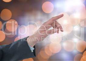 Hand pointing with sparkling light bokeh background