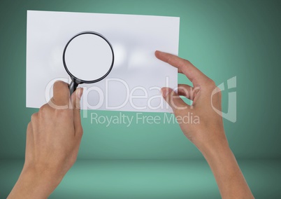 Holding magnifying glass over blank card