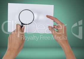 Holding magnifying glass over blank card
