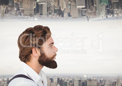 Hipster man looking far away with city as background