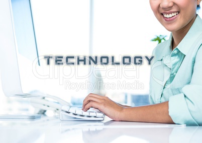 Cropped image of smiling businesswoman working on computer with technology text at office