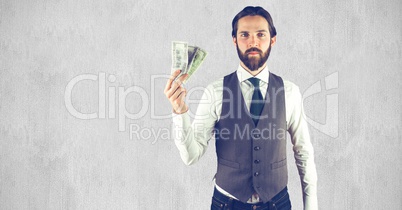 Creative businessman holding currencies while standing against wall