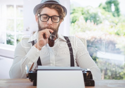 Hipster man  on typewriter with bright windows