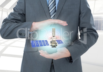 solar panel satellite between businessman  hands with light