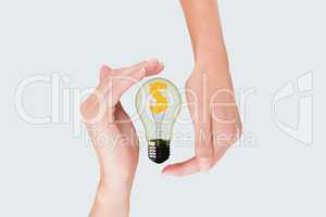 bulb on hands against white background