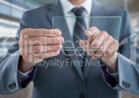 Businessman holding glass tablet