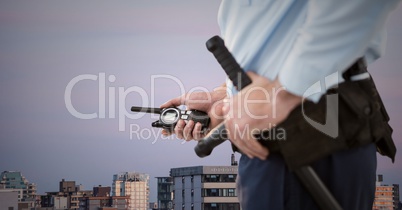 Security guard lower body against buildings and purple sky