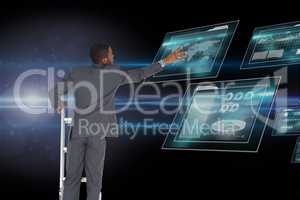 Businessman touching tablet computer screen from the top of the ladder against space background