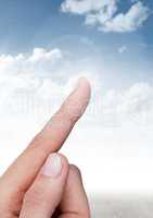 Hand touching air with sky background