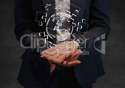 Business woman mid section with white jigsaw doodle in hands against grey wall