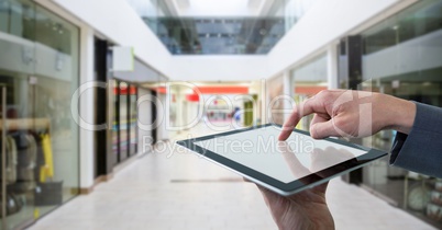 Businessman touching tablet in shopping mall