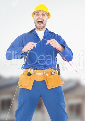 Electrician in shock with wires cables on building site