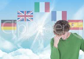 main language flags around young man. Sky background