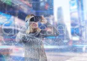 Woman using 3D glasses to see an interface in a futuristic room
