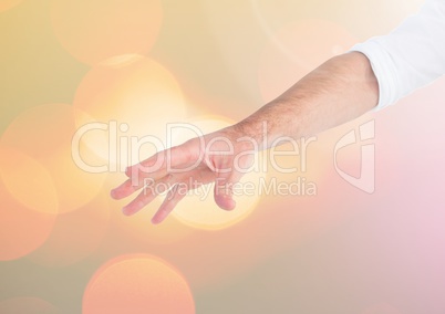 Hand reaching open with sparkling light bokeh background