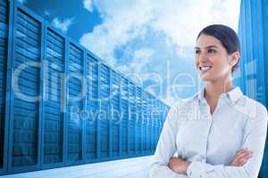 Business woman with arm crossed against the server room